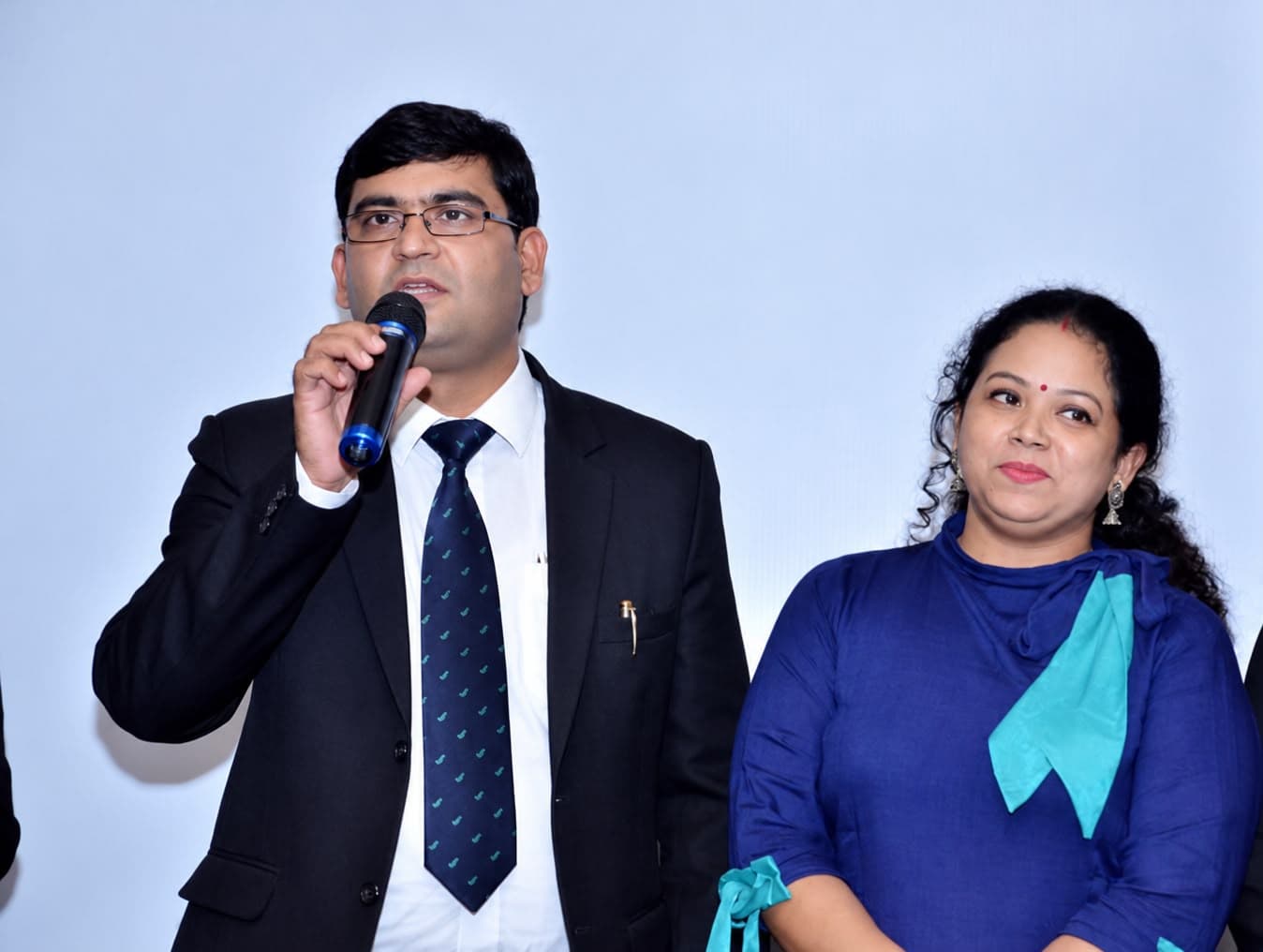 Aadesh Sharma speaking into a microphone during a session